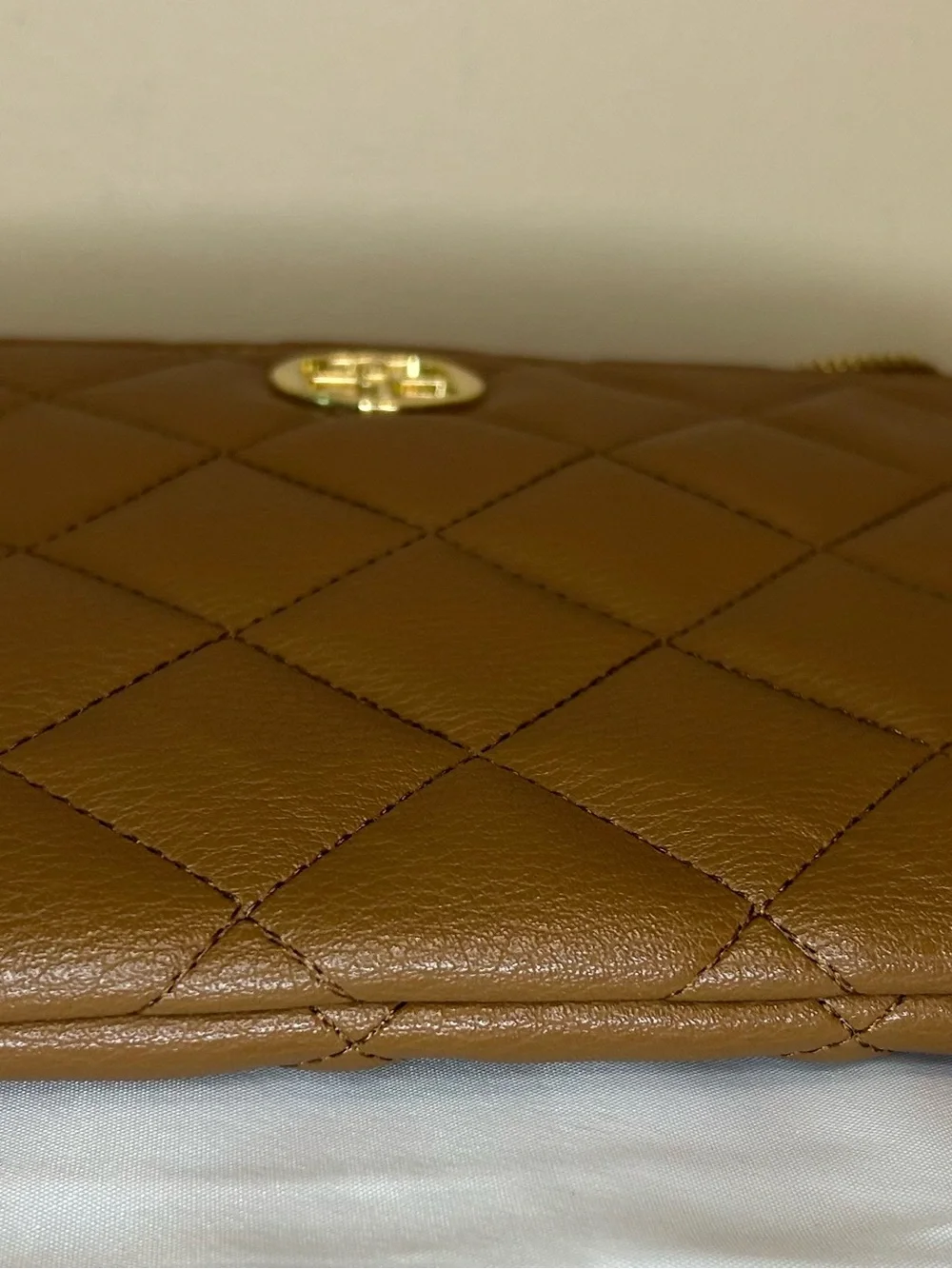 IMAN Quilted Tan Crossbody with Gold Medallion